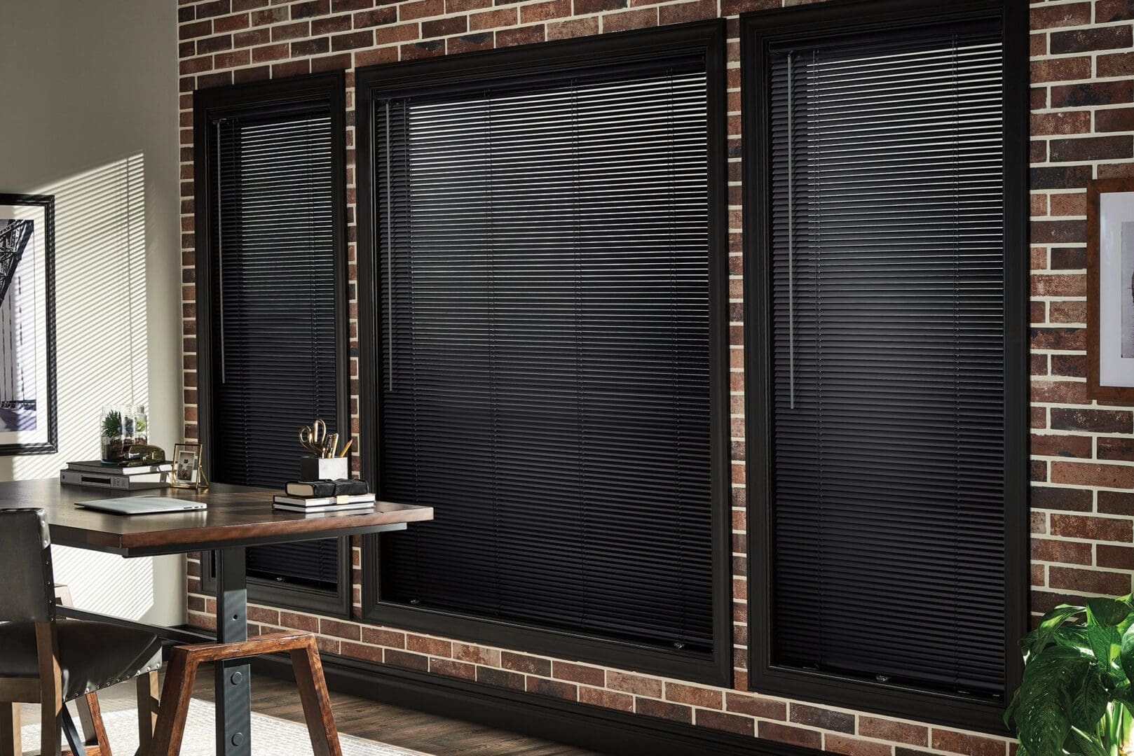 Black window blinds in brick wall office.