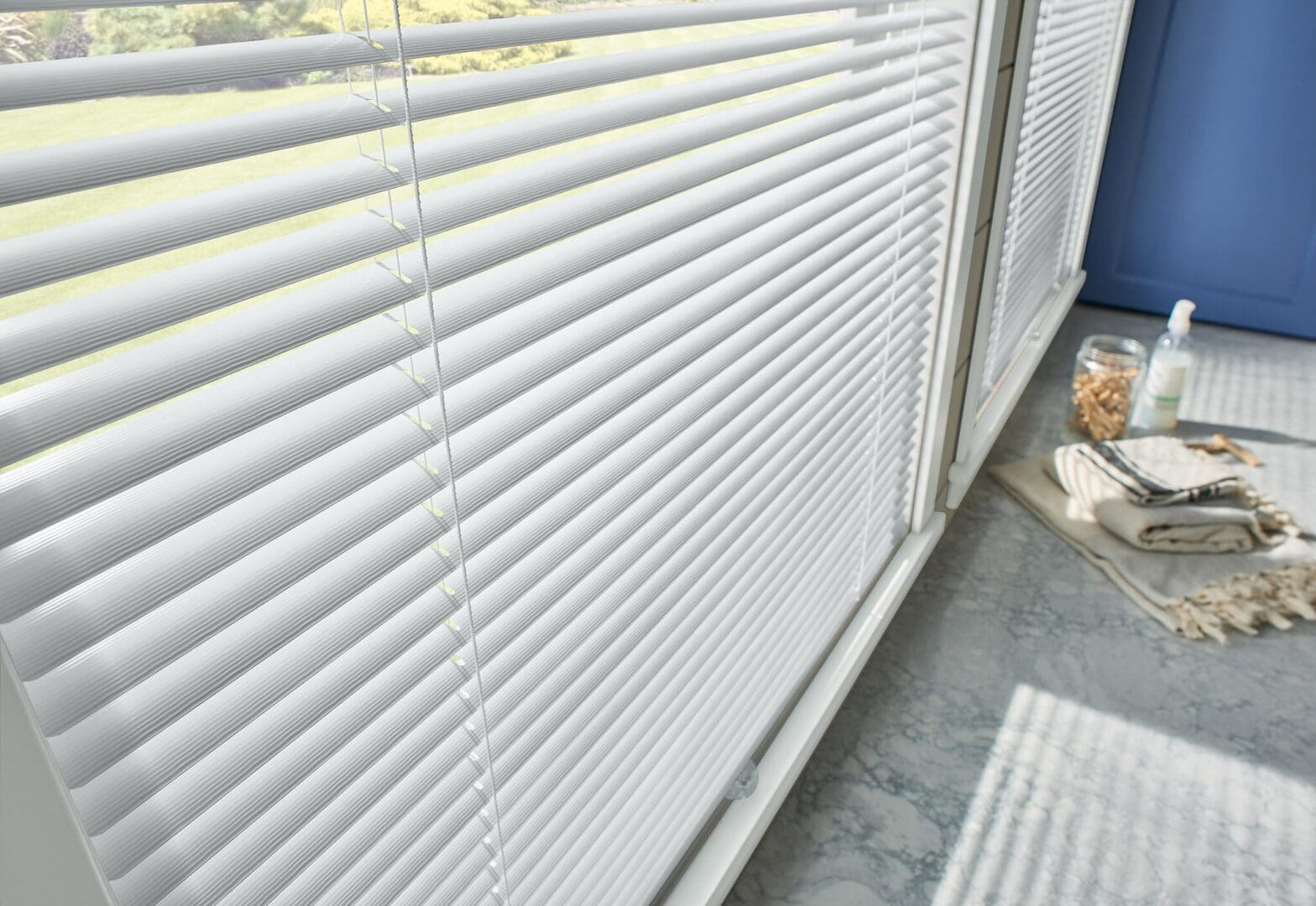 White window blinds in a bathroom.